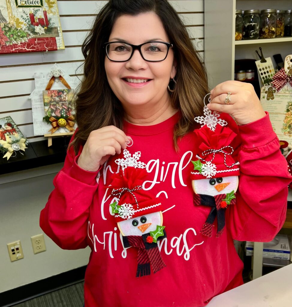 Tracy holding the snowman hoop ornaments
