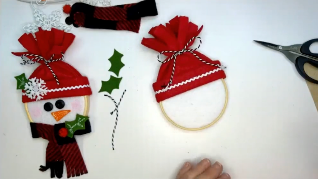 hoop ornament with red hat and tied string