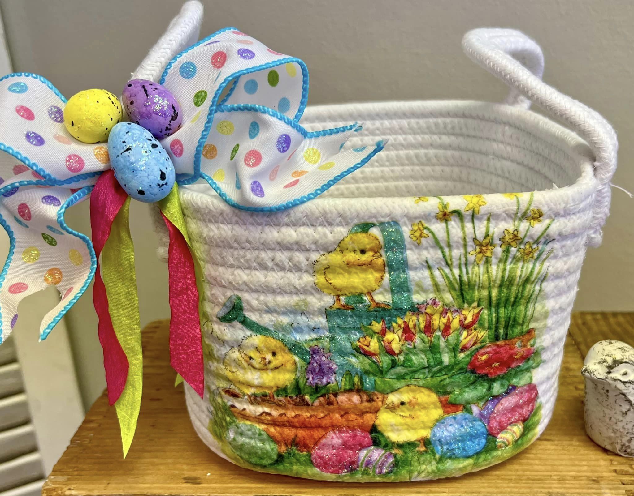 white basket with chicks and eggs on it with bow and dots